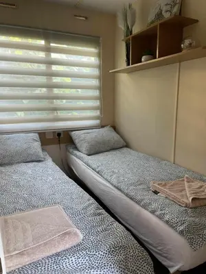 two beds in a small room with a window at Riviera Zator in Zator