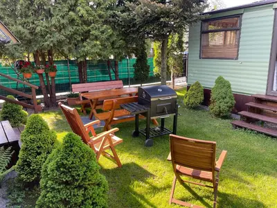 a backyard with a grill and benches and a picnic table at Riviera Zator in Zator
