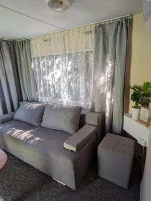 a living room with a couch and a window at Riviera Zator in Zator