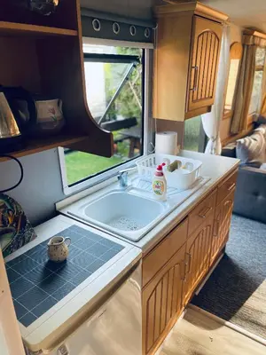 a kitchen with a sink and a window in an rv at Riviera Zator in Zator