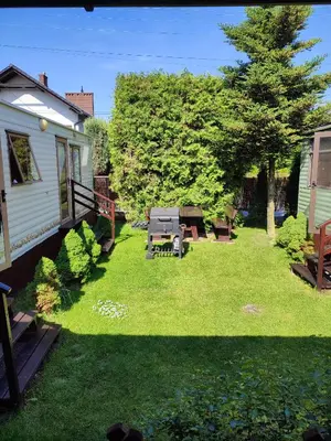 a yard with a picnic table and a tree at Riviera Zator in Zator