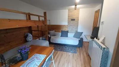 a room with a couch and a table and a desk at Pokoje Gościnne U Ewy in Wieliczka