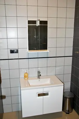 a bathroom with a white sink and a window at Motel Lunar in Oświęcim