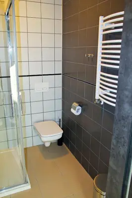 a bathroom with a toilet and a glass shower at Motel Lunar in Oświęcim