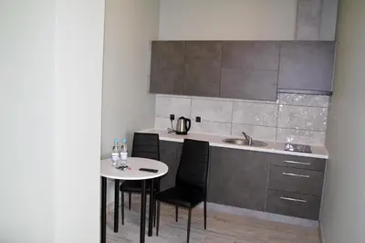 a kitchen with a table and chairs and a sink at Motel Lunar in Oświęcim