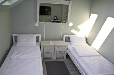 two beds in a small room with a mirror at Motel Lunar in Oświęcim