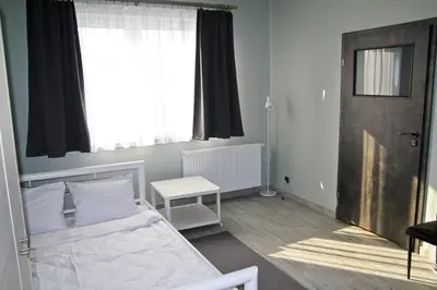 a small bedroom with a bed and a window at Motel Lunar in Oświęcim