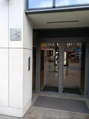 an entrance to a building with a sign on the door at Kościuszki 28 A by Homeprime in Kraków