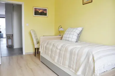 a bedroom with a bed and a chair at Kościuszki 28 A by Homeprime in Kraków