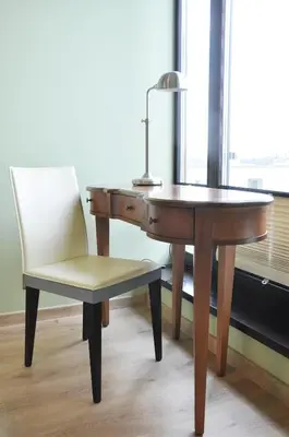 a desk and a chair next to a desk and a lamp at Kościuszki 28 A by Homeprime in Kraków