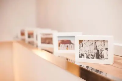 a row of pictures on a shelf in a room at Rainbow Apartments 1 in Kraków
