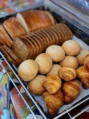 a bunch of different types of bread and pastries at Rainbow Apartments 1 in Kraków