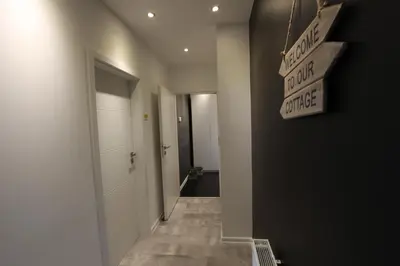 a hallway with a sign that reads walk thru divorce at Rainbow Apartments 1 in Kraków