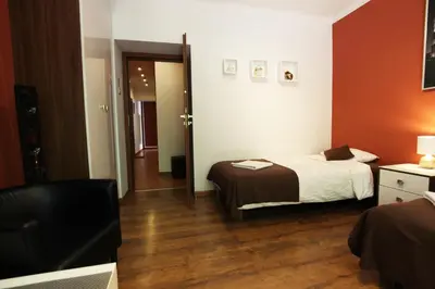a hotel room with a bed and a television at Rainbow Apartments 1 in Kraków
