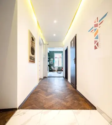 an open hallway with white walls and a wooden floor at Das Hostel in Kraków