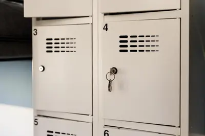 a row of white lockers with a key at Das Hostel in Kraków