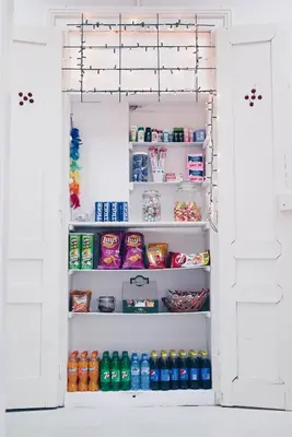 an open refrigerator filled with lots of food and drinks at Das Hostel in Kraków