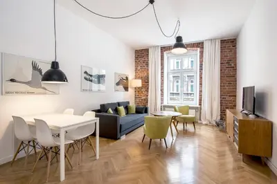 a living room with a couch and a table at Relaks Apartamenty in Kraków
