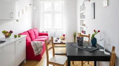 a living room with a red couch and a table at City View Apartments in Kraków