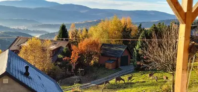 a house on top of a hill with a stone wall at Podbucznik 1 Pilsko in Targoszów