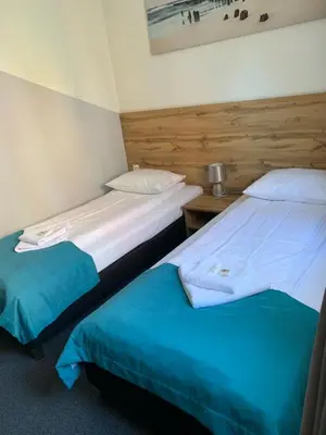 two twin beds in a room with at Villa Centro in Oświęcim