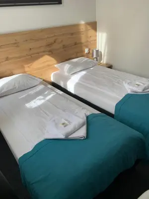 two beds sitting next to each other in a room at Villa Centro in Oświęcim