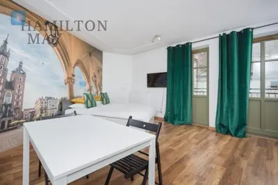 a bedroom with a white table and green curtains at Tweety Cracow House in the Old Town in Kraków