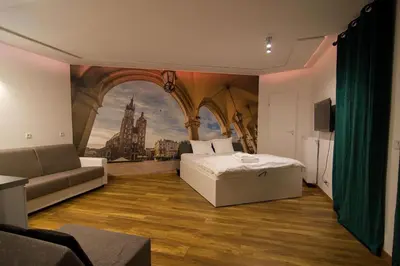 a bedroom with a bed and a painting on the wall at Tweety Cracow House in the Old Town in Kraków