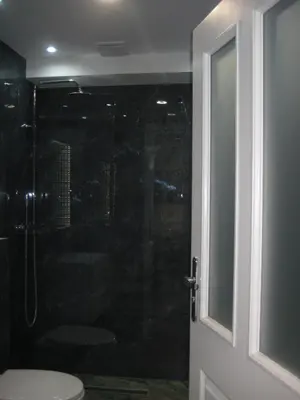 a bathroom with a shower and a toilet with a glass door at Tweety Cracow House in the Old Town in Kraków