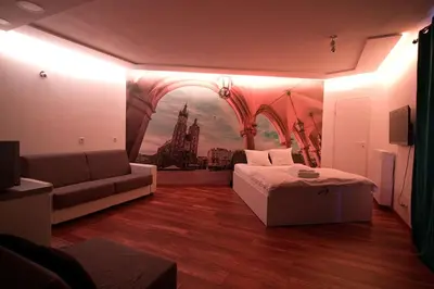 a living room with a couch and a painting on the wall at Tweety Cracow House in the Old Town in Kraków