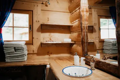 a bathroom with a sink in a log cabin at Jarogówka Stylowy dom góralski in Obidowa