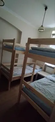a bedroom with two bunk beds in a room at Hostel ALEX&TSA in Kraków