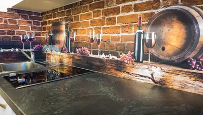 a kitchen with a sink and a wine barrel at Apartamenty Idylla in Kraków