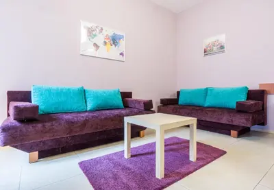 a living room with two couches and a table at Apartamenty Idylla in Kraków