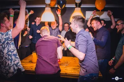 a group of people dancing at a party at Greg&Tom Party Hostel in Kraków