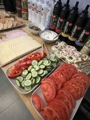 a table topped with different types of vegetables on plates at Greg&Tom Party Hostel in Kraków
