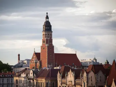 a tall building with a clock tower in a city at The Loft Hotel Adults Only in Kraków