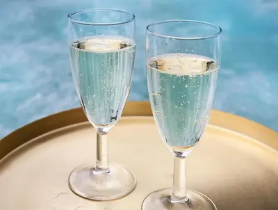 two glasses of champagne sitting on a table at The Loft Hotel Adults Only in Kraków