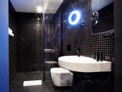a bathroom with a sink and a toilet and a shower at The Loft Hotel Adults Only in Kraków