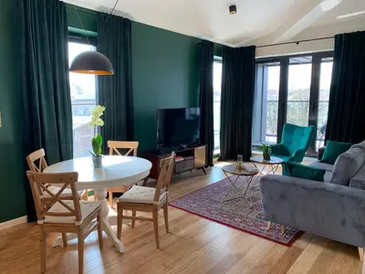 a living room with a table and a couch at AGIHOME Rajska 3 Apartments in Kraków
