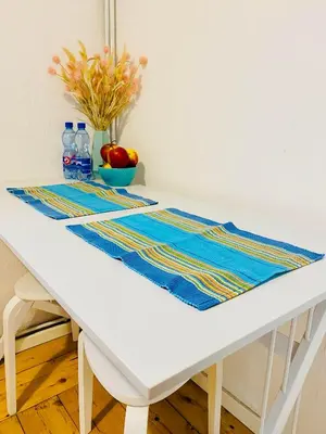 a white table with a blue and yellow table runner on it at Apartment in Ivy covered house, near Old Town in Kraków