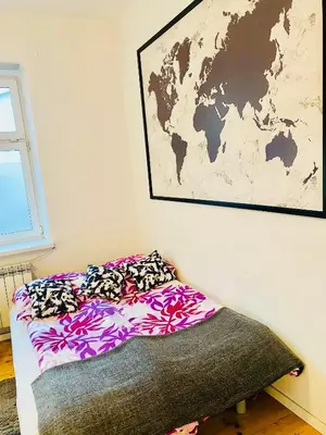 a bed in a room with a map on the wall at Apartment in Ivy covered house, near Old Town in Kraków