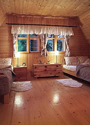a bedroom with two beds in a log cabin at DOM NAD POTOKIEM in Zawoja