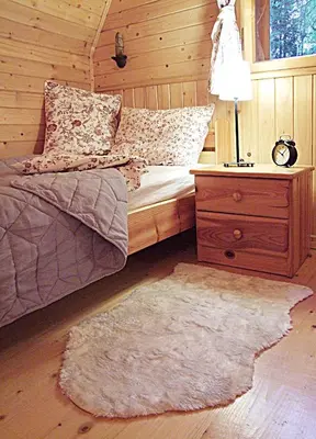 a bedroom with a bed and a night stand with a lamp at DOM NAD POTOKIEM in Zawoja