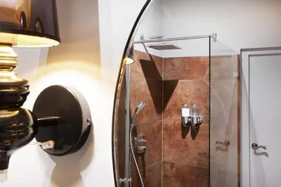 a bathroom with a shower with a glass door at Art Apartment in Kraków