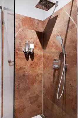 a shower in a bathroom with a glass door at Art Apartment in Kraków