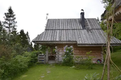 a log cabin with a tin roof on a yard at Mountain chalet SmoLenisko domek w górach in Nowy Targ