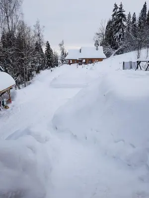 a road covered in snow in front of a house at Mountain chalet SmoLenisko domek w górach in Nowy Targ