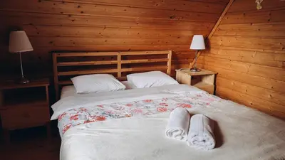 a bedroom with a bed with two towels on it at Mountain Cottage Lubomierz in Lubomierz