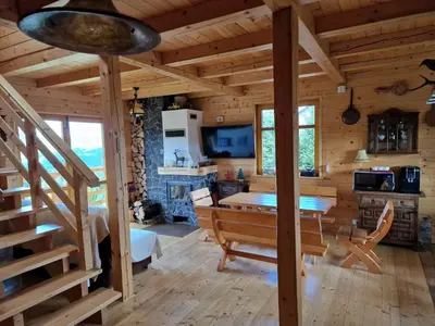 a dining room and kitchen in a log cabin at Zawoja hrabkowa Jastrzębowka in Zawoja